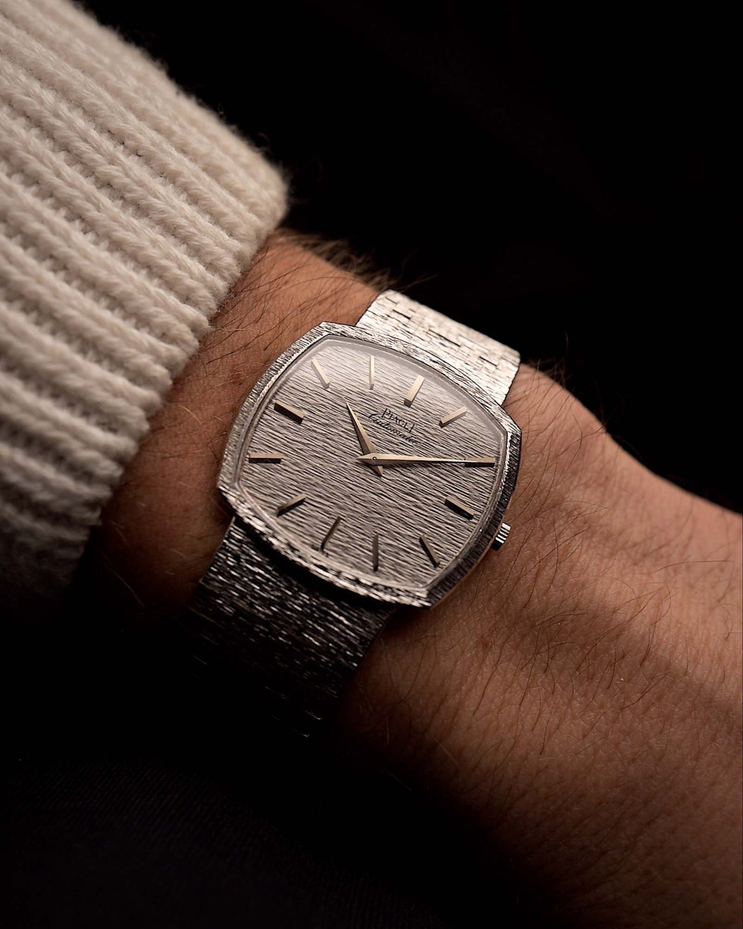 Vintage Piaget TV 12401 Bark watch Vintage Watch 18k white gold TV case white hammered dial Cal 12P1 on integrated bracelet on black background